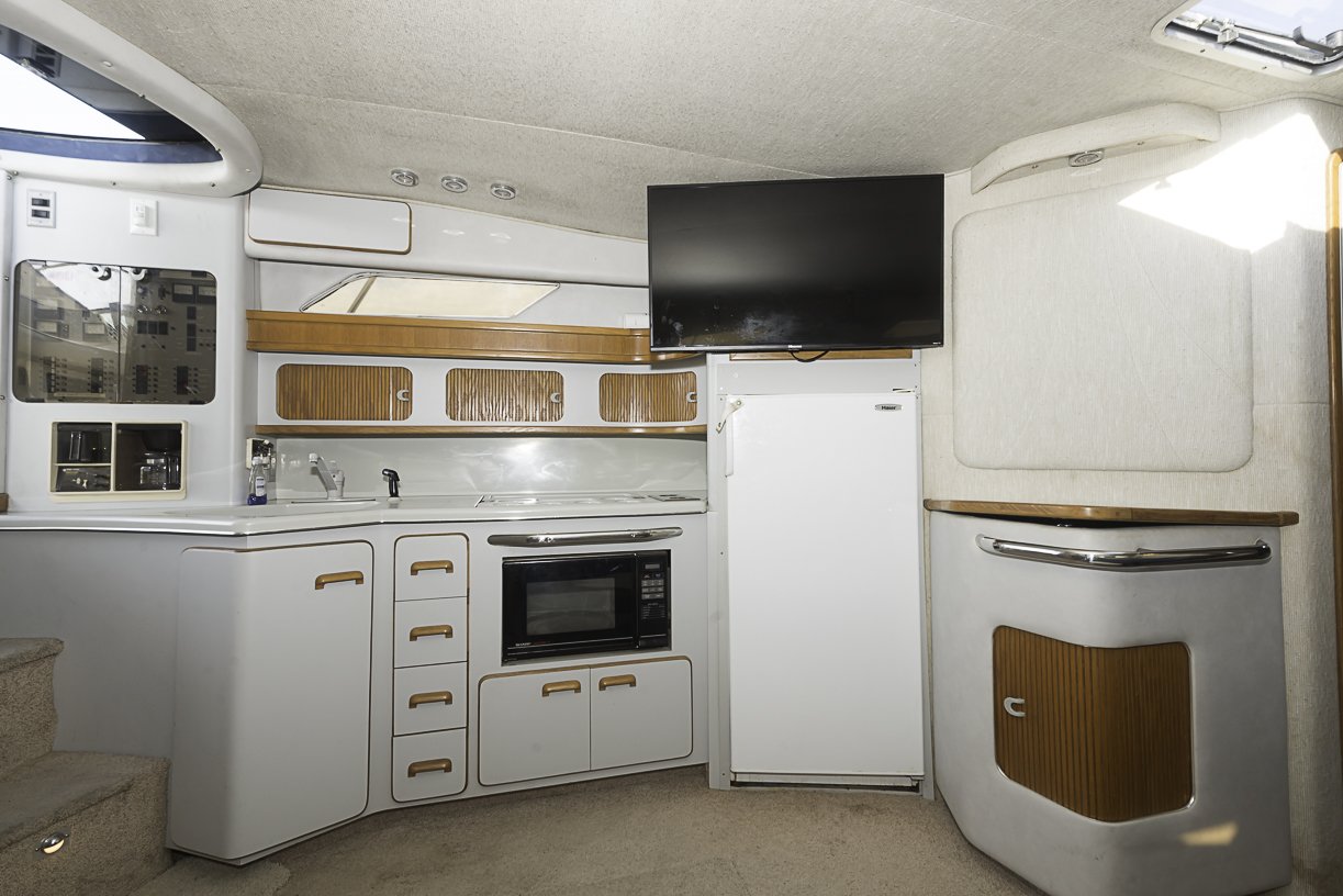 Onboard cabin with galley, refrigerator, and amenities