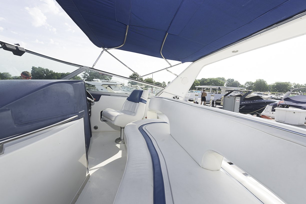 Captain's helm and seating with marina view