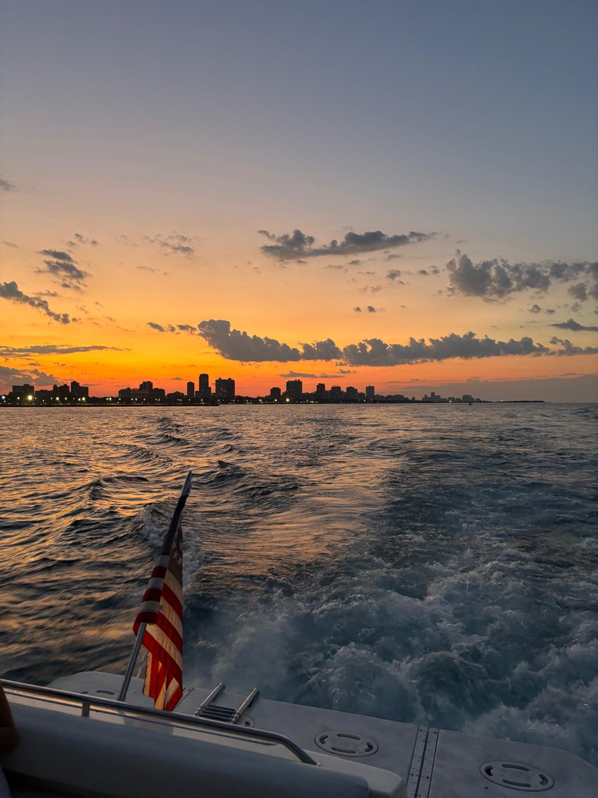 Yacht on Lake Michigan with Chicago skyline and clouds