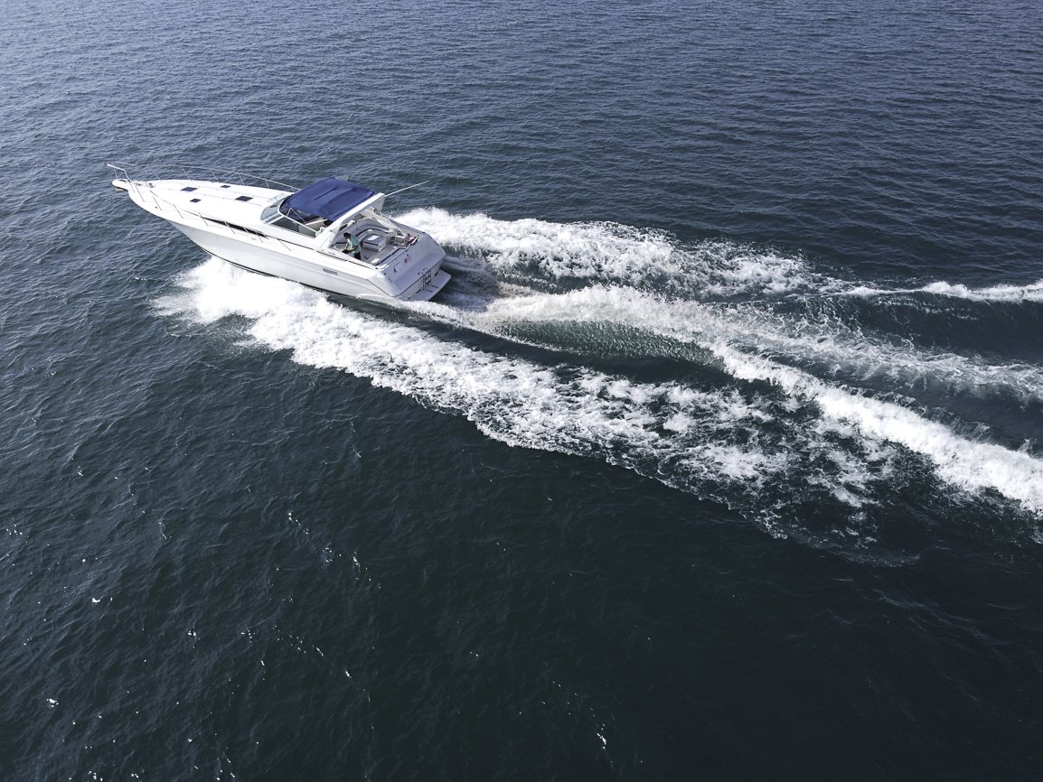 Drone shot of yacht cutting through Lake Michigan waves